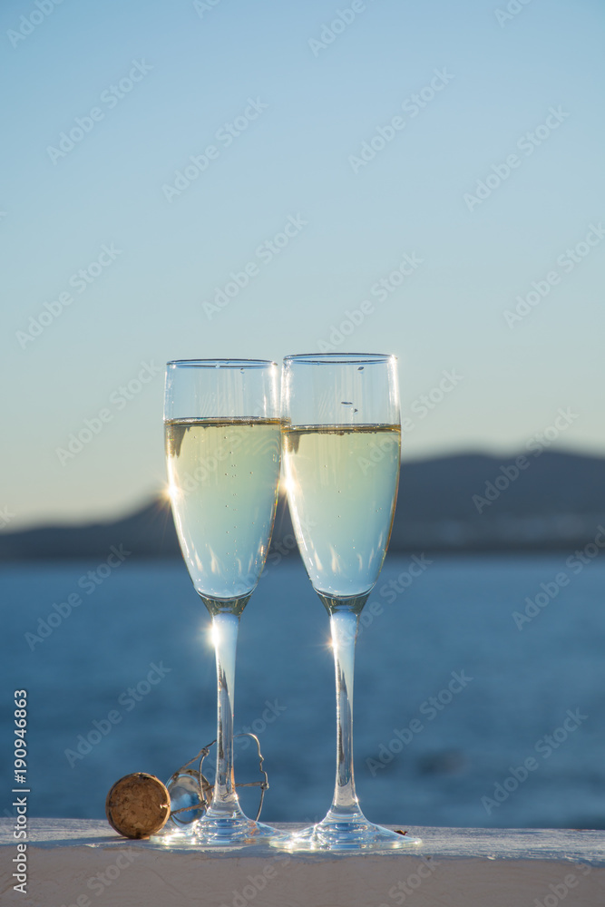 Two glasses with champain or cava served outside on terrace, luxury resort with sea view, romantic vacation Two glasses with champain or cava served outside on terrace, luxury resort with sea view, romantic vacation