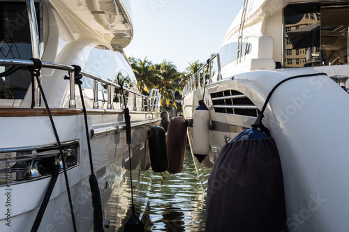 Stampa su tela Boat fenders hanging above luxury white yacht.