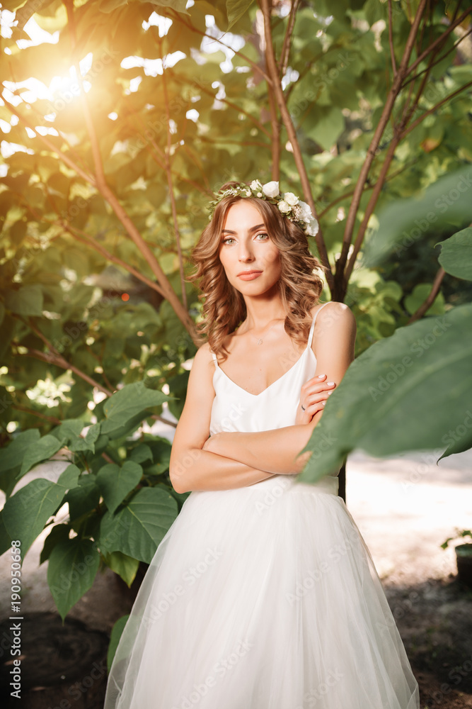 Full length side view of one beautiful sensual young blonde bride in long white wedding dress Full length side view of one beautiful sensual young blonde bride in long white wedding dress
