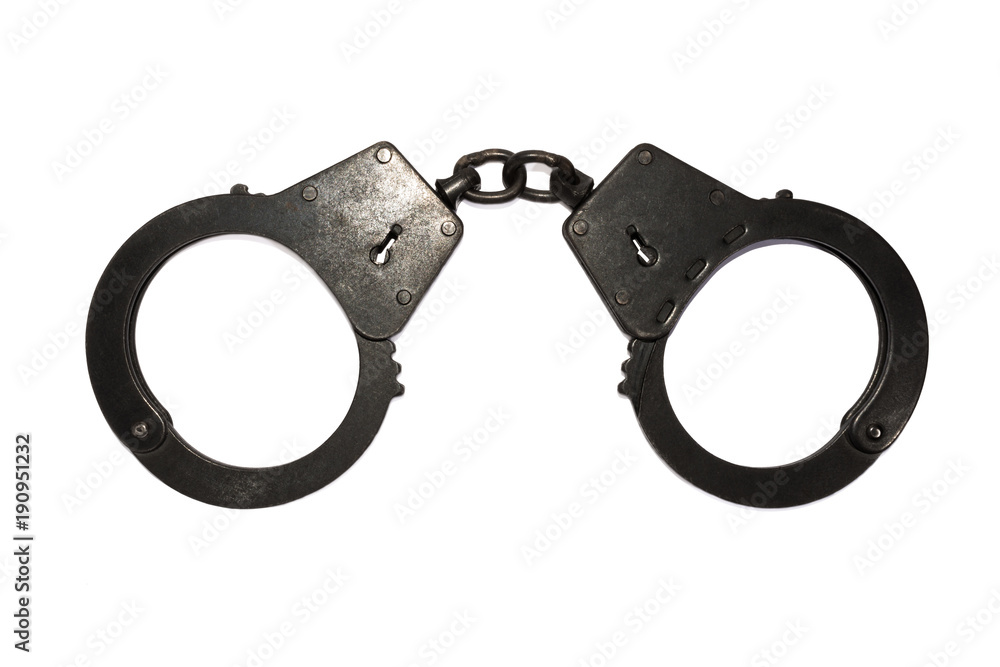 black metal handcuffs with small scratches on white background black metal handcuffs with small scratches on white background