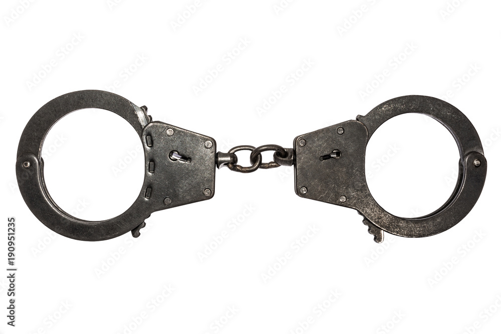black metal handcuffs with small scratches on white background black metal handcuffs with small scratches on white background