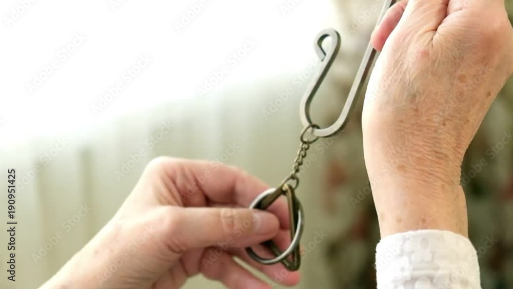 An old woman unravels a metal puzzle, coaches brain activity An old woman unravels a metal puzzle, coaches brain activity