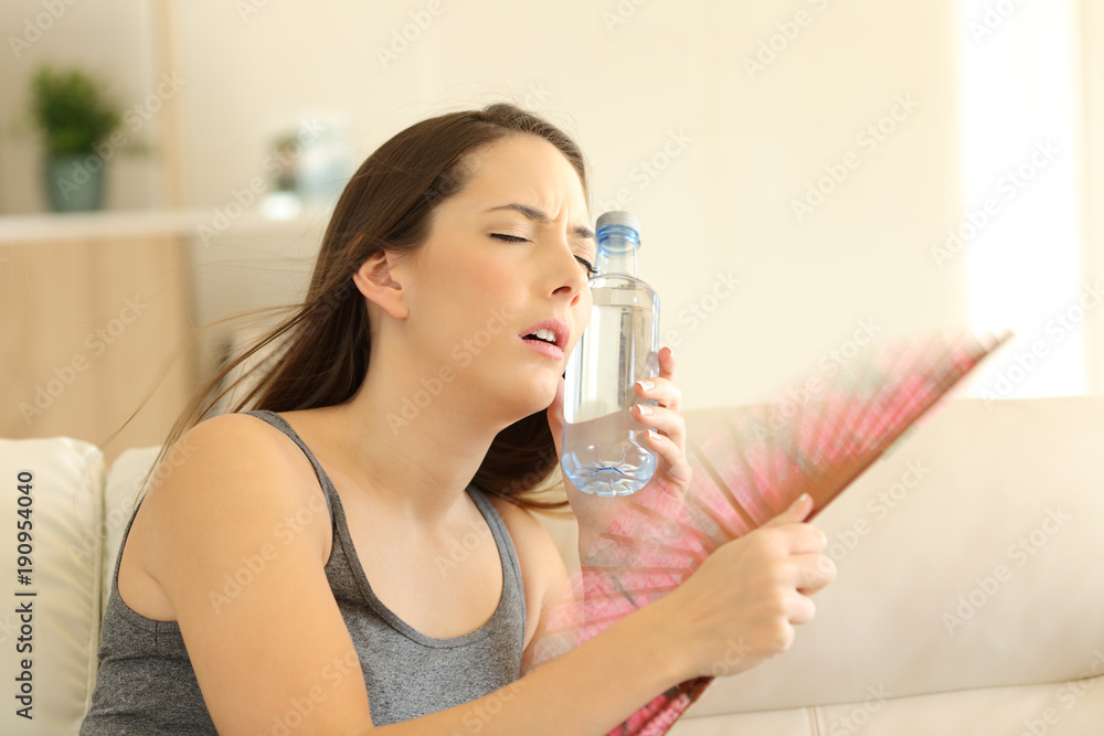 Girl suffering a heatstroke refreshing with a fan Girl suffering a heatstroke refreshing with a fan
