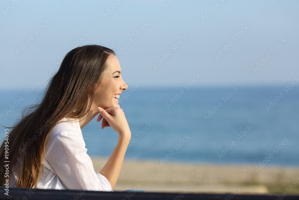 Smiley woman looking forward on the beach Smiley woman looking forward on the beach