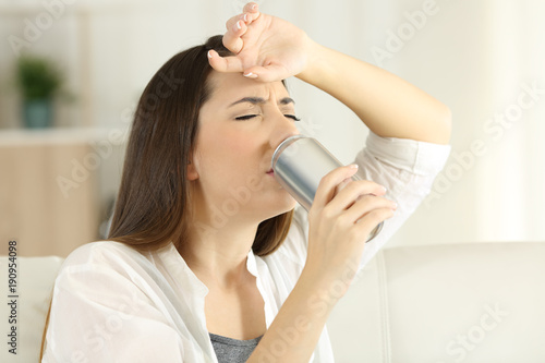 Thirsty girl sugffering heatstroke and drinking soda
