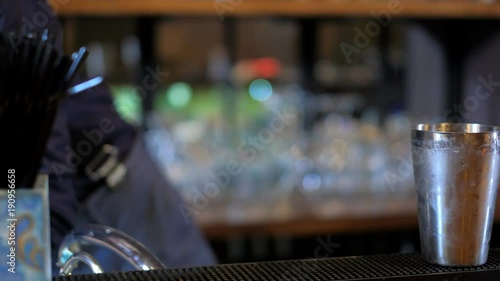 Expert barman is making cocktail at bar photo