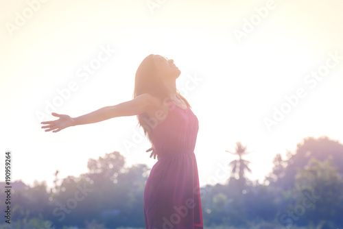 Young beauty woman happy relaxing smile in summer sunset sky outdoor