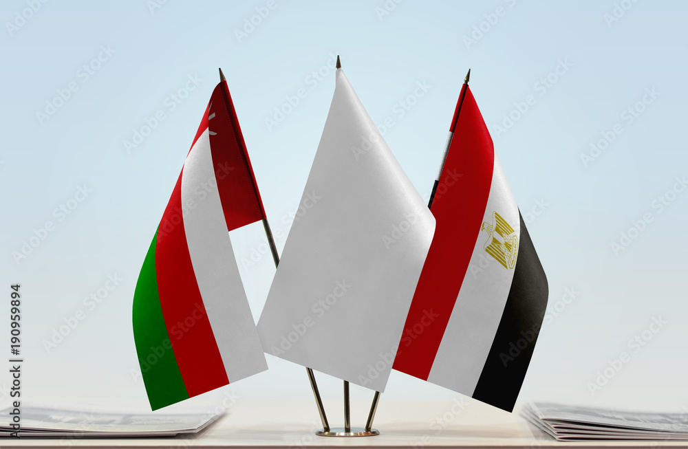 Flags of Oman and Egypt with a white flag in the middle