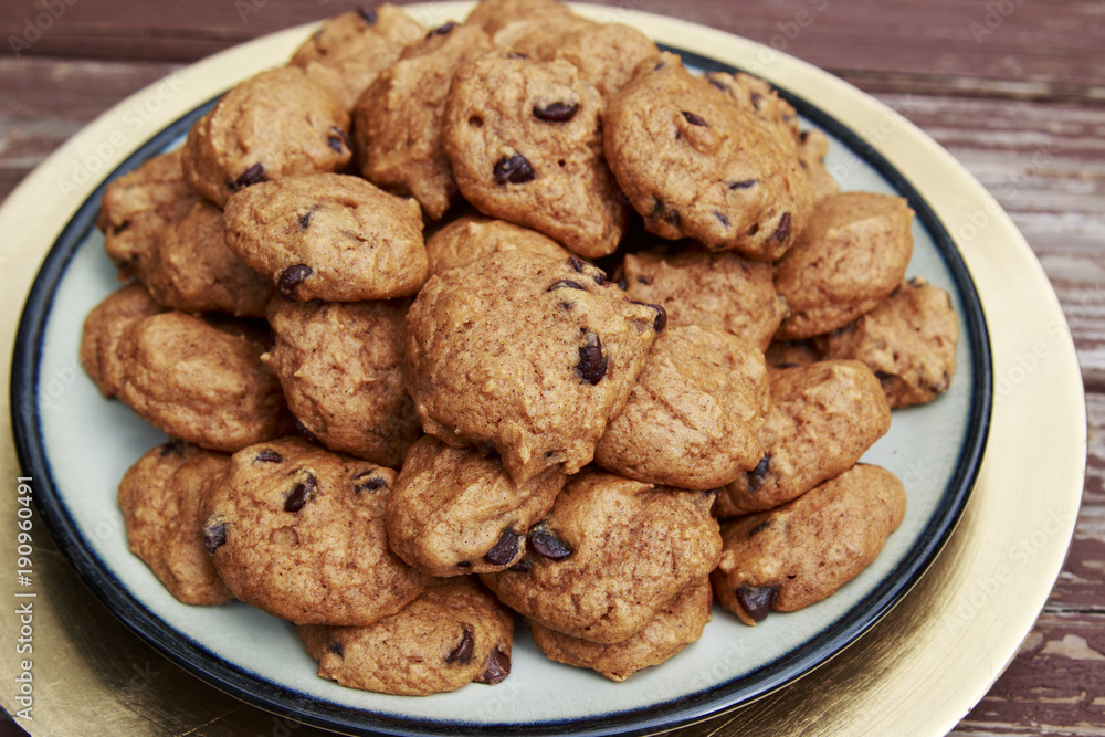 Pumpkin Chocolate Chip cookies served on a golden plate Pumpkin Chocolate Chip cookies served on a golden plate