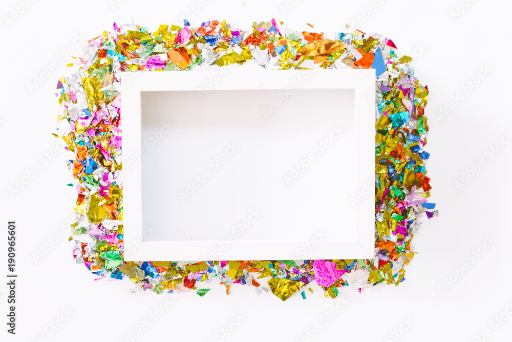 White photo frame with colorful paper on white background.flat lay, top view White photo frame with colorful paper on white background.flat lay, top view