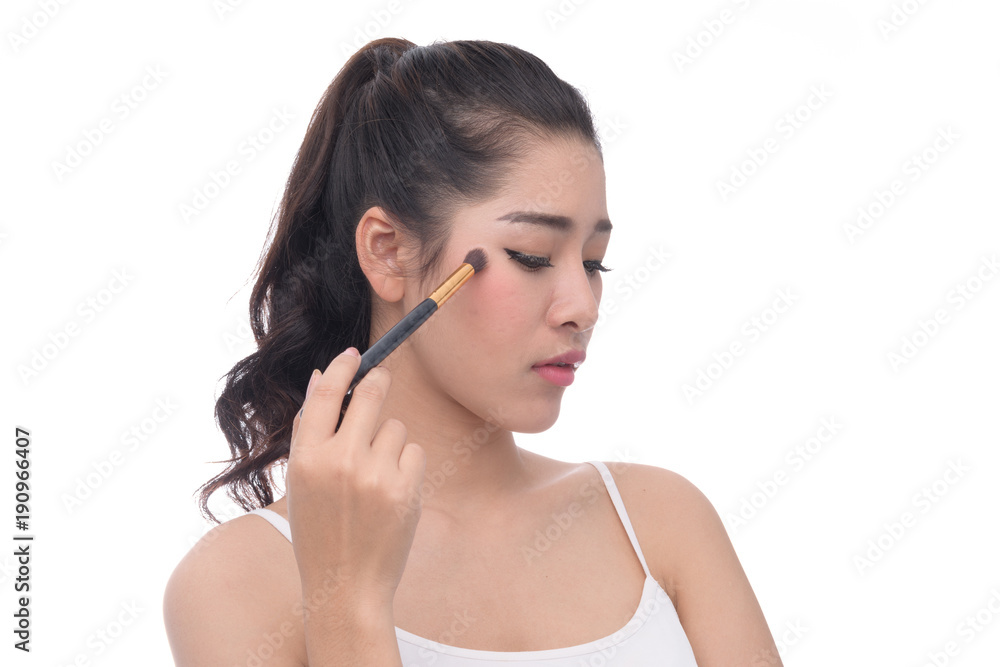 Beauty asian women with clean skin puts on makeup on white background. Beauty asian women with clean skin puts on makeup on white background.