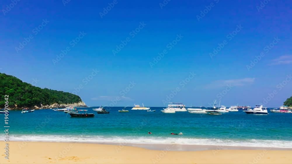 Snorklers and yachts in the bay at Playa el Maguey, Oaxaca, Mexico. Snorklers and yachts in the bay at Playa el Maguey, Oaxaca, Mexico.