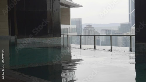 Slow motion shot of female feet walking on the bottom of a pool. Water splashes. photo