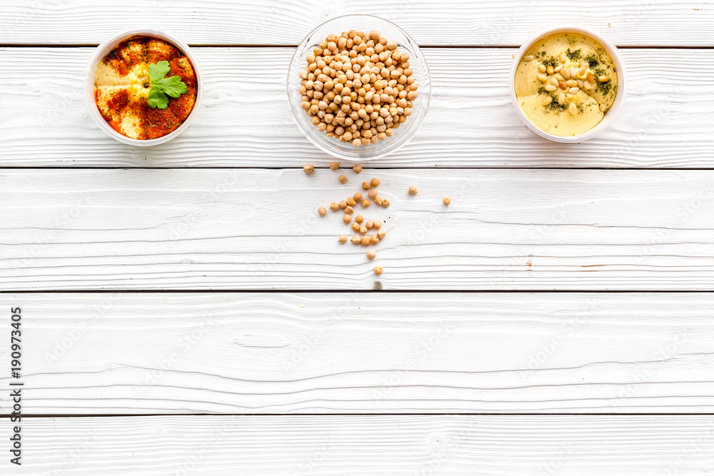 Cook chickpeas. Make hummus. Bowls with grains and ready meal on white wooden background top view copy space Cook chickpeas. Make hummus. Bowls with grains and ready meal on white wooden background top view copy space