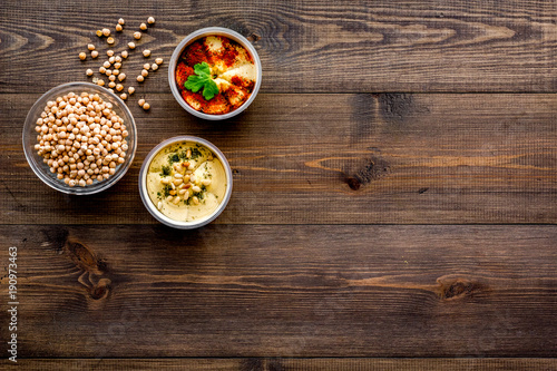 Cook chickpeas. Make hummus. Bowls with grains and ready meal on dark wooden background top view copy space