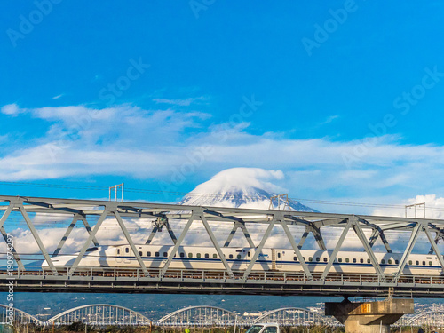 Fuji mountain with bullet train or shinkansen in foreground.