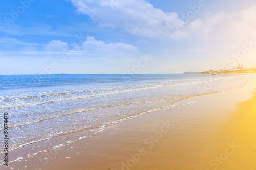 The sea and the beach under the blue sky and white clouds