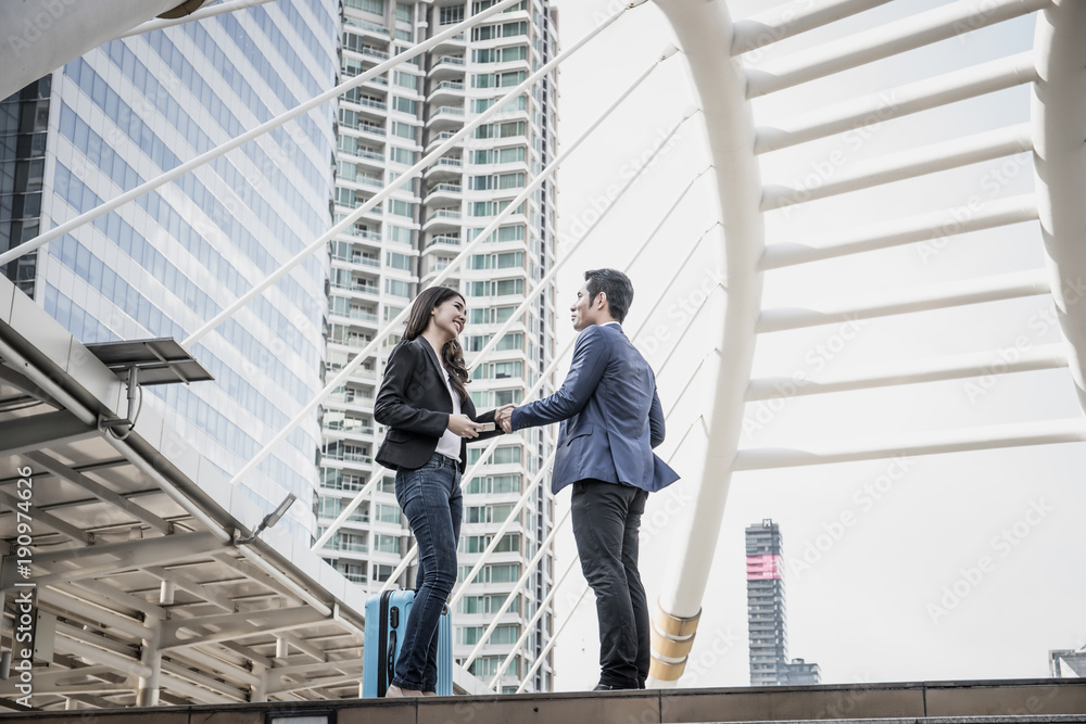 Business partner work hands shaking while looking at successful work at tablet. Business concept. Business partner work hands shaking while looking at successful work at tablet. Business concept.