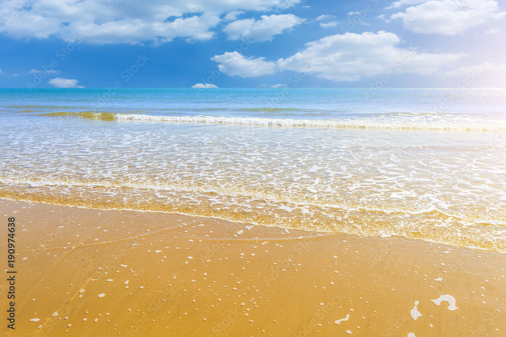 The sea and the beach under the blue sky and white clouds The sea and the beach under the blue sky and white clouds