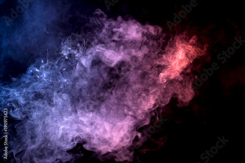 Cloud of smoke of purple, red and blue colors on black isolated background. Background from the smoke of vape