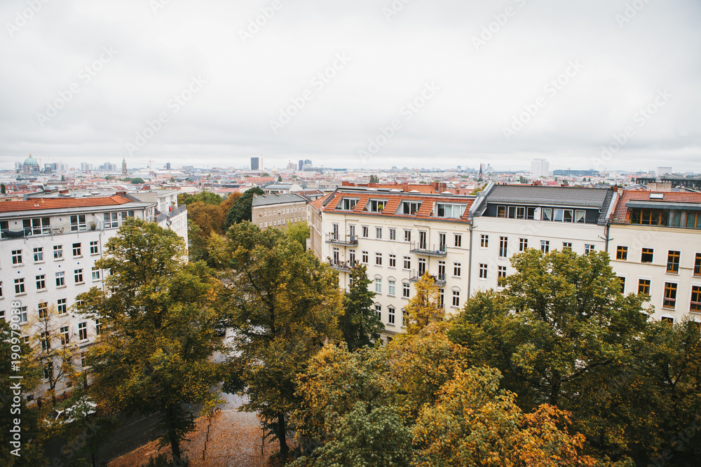 View from high point to the street with buildings with trees in Berlin in Germany. Architecture of the big city.