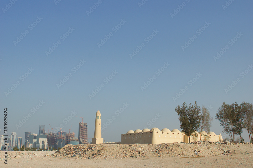 Mosque Minaret with Doha Skyline in Background - Old and new 
