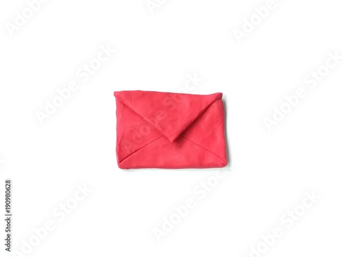 Red envelopes made from plasticine clay dough placed on white background