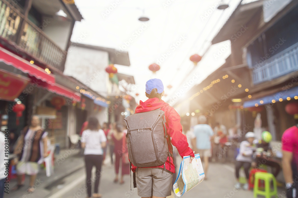 Obraz premium Beautiful woman traveler holding location map in hands.