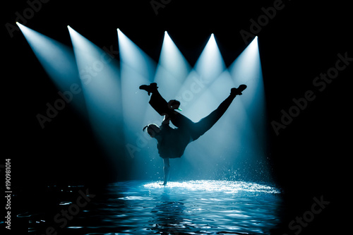 Performance on the water of a dance group against the background of club light.