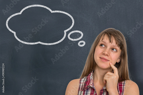 Thoughtful woman with thought bubble on blackboard