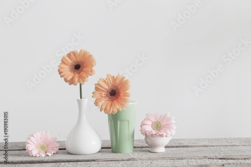 gerbera flowers in vase on wooden table © Maya Kruchancova