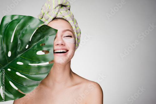Canvas Print happy woman with a towel on her head after the shower has put patches under the