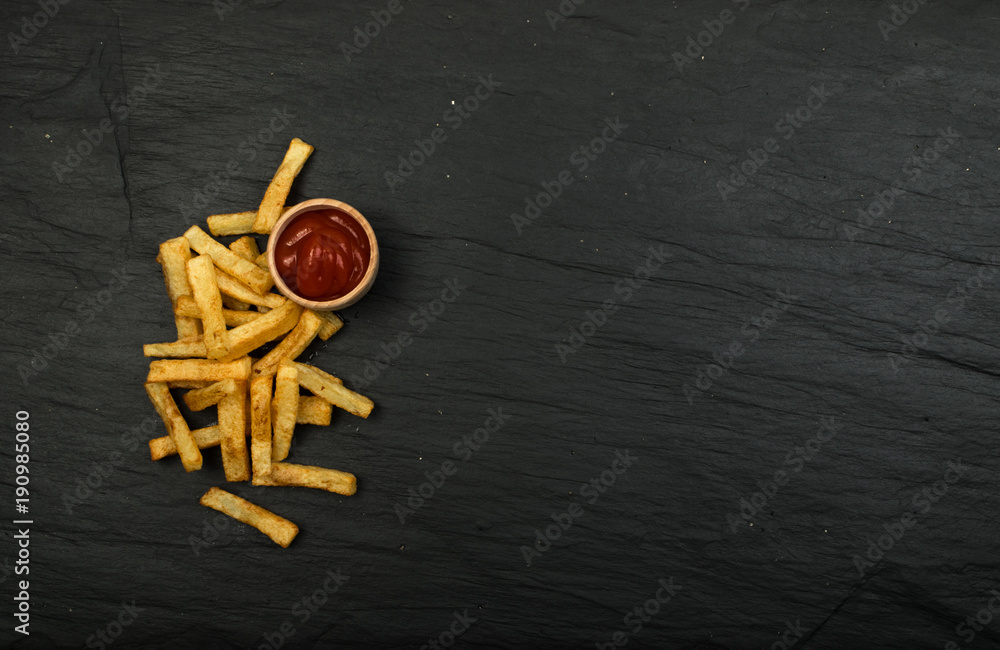French Fries with Ketchup on Dark Background French Fries with Ketchup on Dark Background