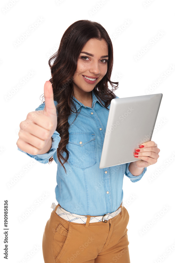 smiling casual woman holding tablet makes ok sign smiling casual woman holding tablet makes ok sign