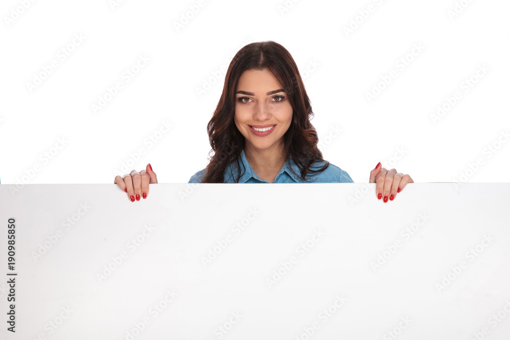 smiling young casual woman holding a large billboard smiling young casual woman holding a large billboard