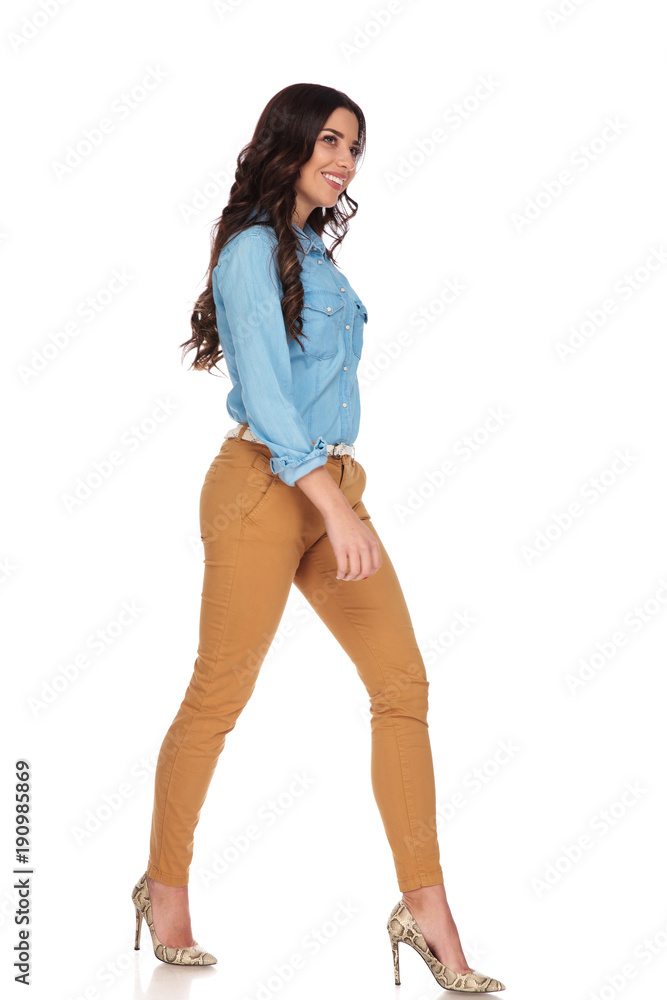 happy young woman walking and looks away happy young woman walking and looks away