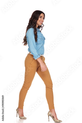 happy young woman walking and looks away