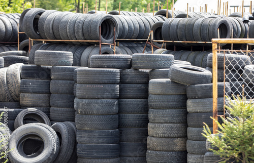A large stack of used automotive car tires