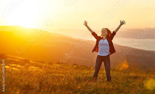 Happy woman on sunset in nature iwith open hands