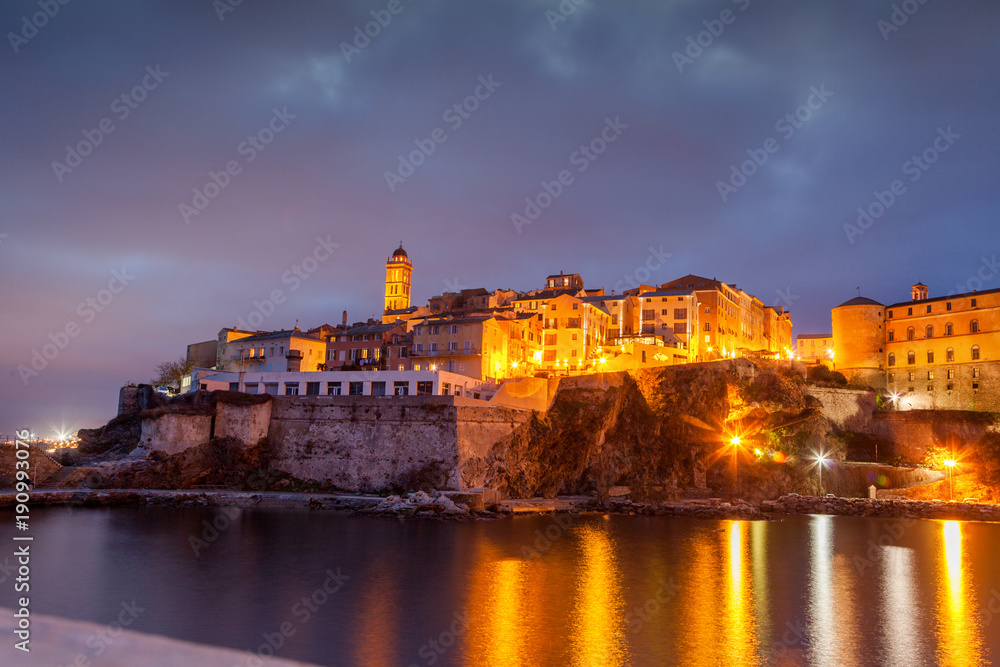 Bastia, a beautiful city landscape, a port with boats, a sunset and the lights of a night city. France, Corsica, a popular destination for travel in Europe