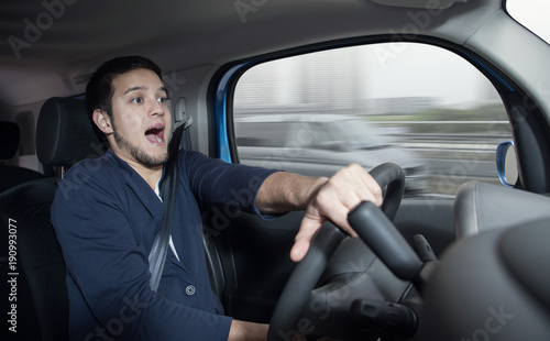Surprised driver in the car.　Car accident. Abrupt steering. © metamorworks