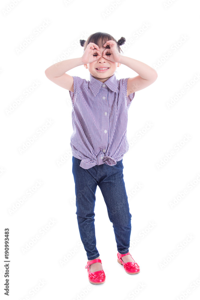 Little asian girl smiling while standing over white background Little asian girl smiling while standing over white background