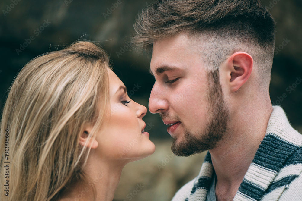 Young pretty pair of lovers. Winter. Date. A pair of lovers on a date in the mountains.