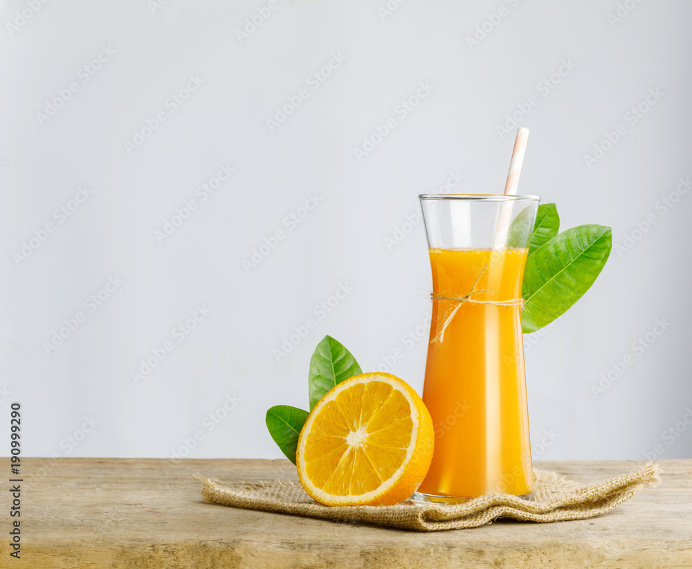 Glass of fresh orange juice on wooden table, Fresh fruits Orange juice