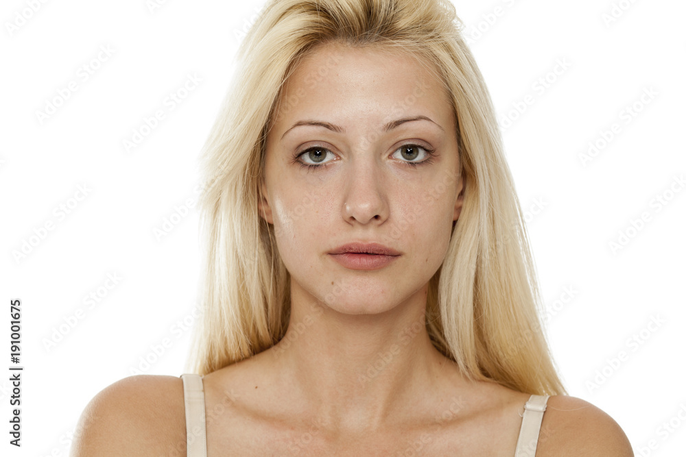 Young blonde woman without makeup on white background Young blonde woman without makeup on white background