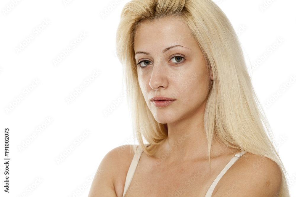 Young blonde woman without makeup on white background Young blonde woman without makeup on white background