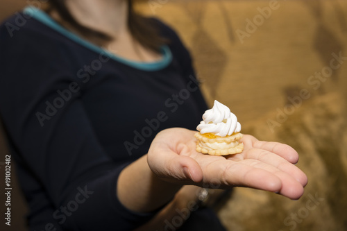 Christmas candy offered on the palm of a woman's hand.