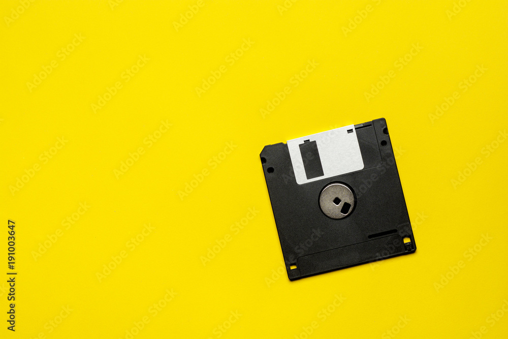 floppy data storage diskette on yellow background with copy space floppy data storage diskette on yellow background with copy space
