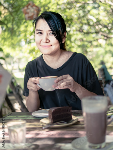 Portrait of woman smiling with a cup of hot Cappuccino