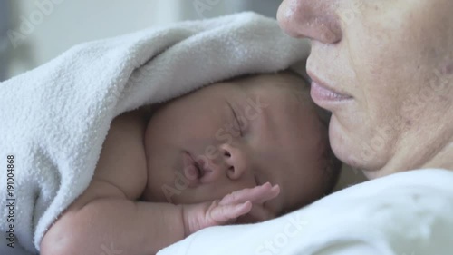 Newborn baby lying in his mother's chest in the hospital
